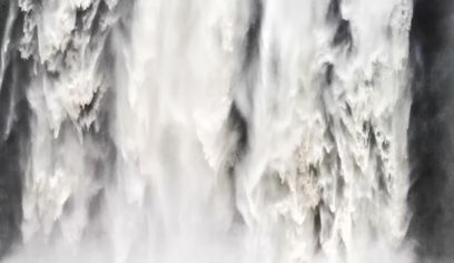 Seljalandsfoss on South Shore Coast in Iceland. Man standing in front of gigantic waterfall