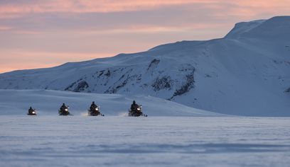 Snowmobiling in Langjökull at Sunset Pink sky