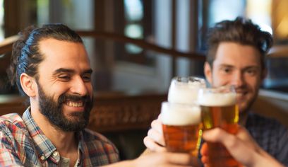 Two men saying cheers to being in Reykjavík Iceland. Beer.